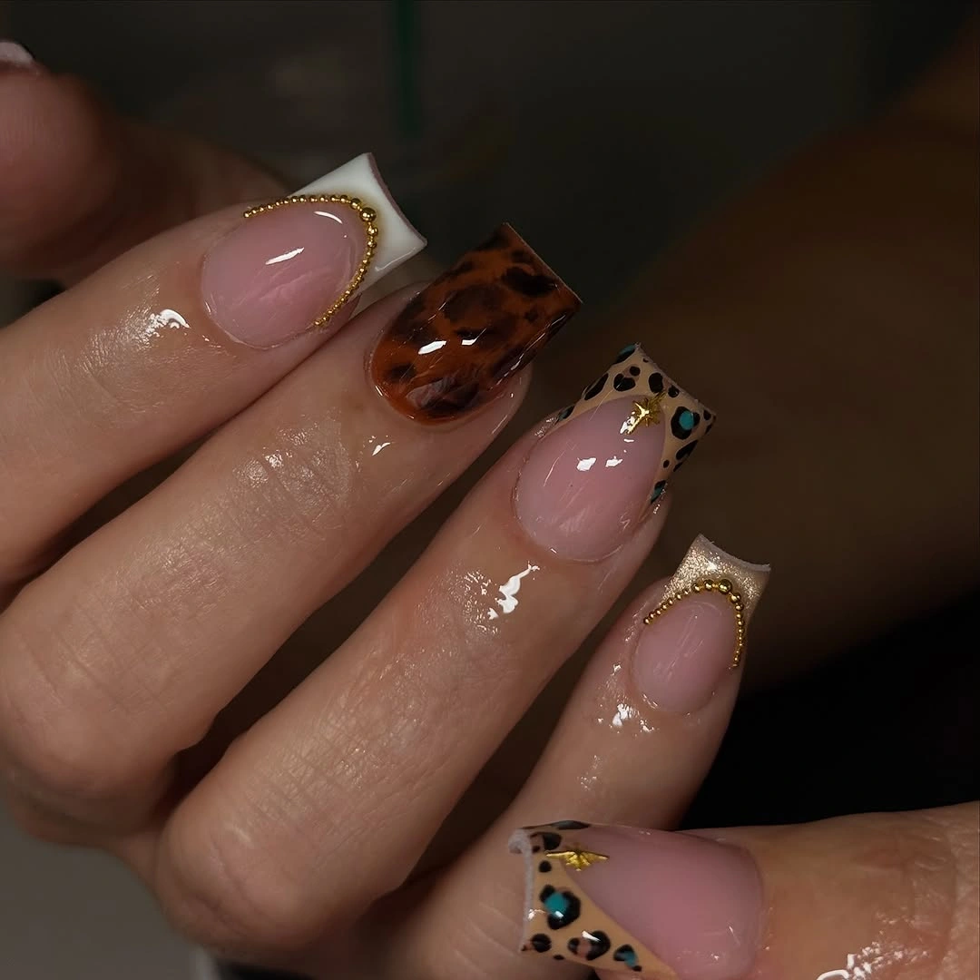 Extended nude square nails with animal print and gold trim