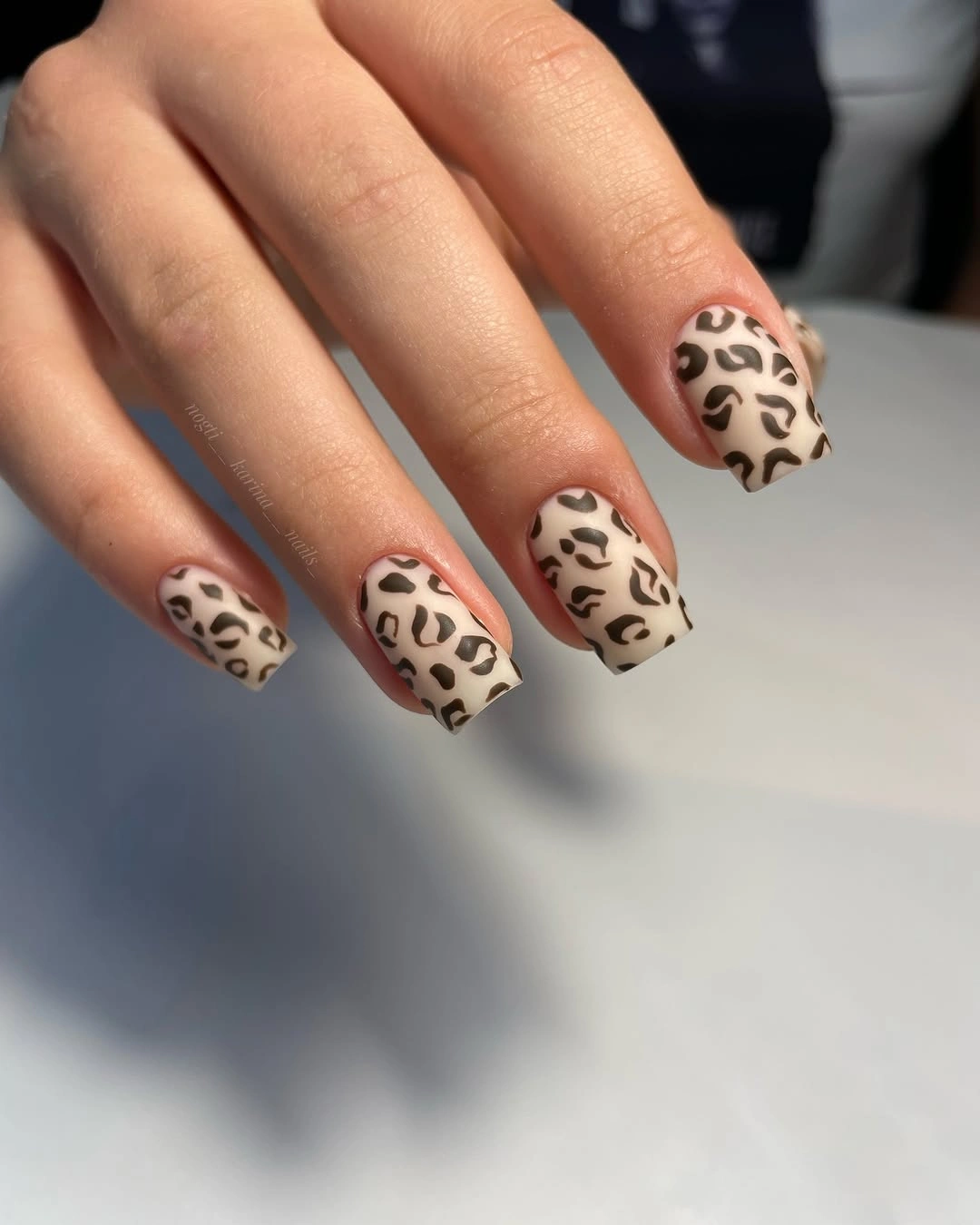Squared nude beige nails with full black leopard spots