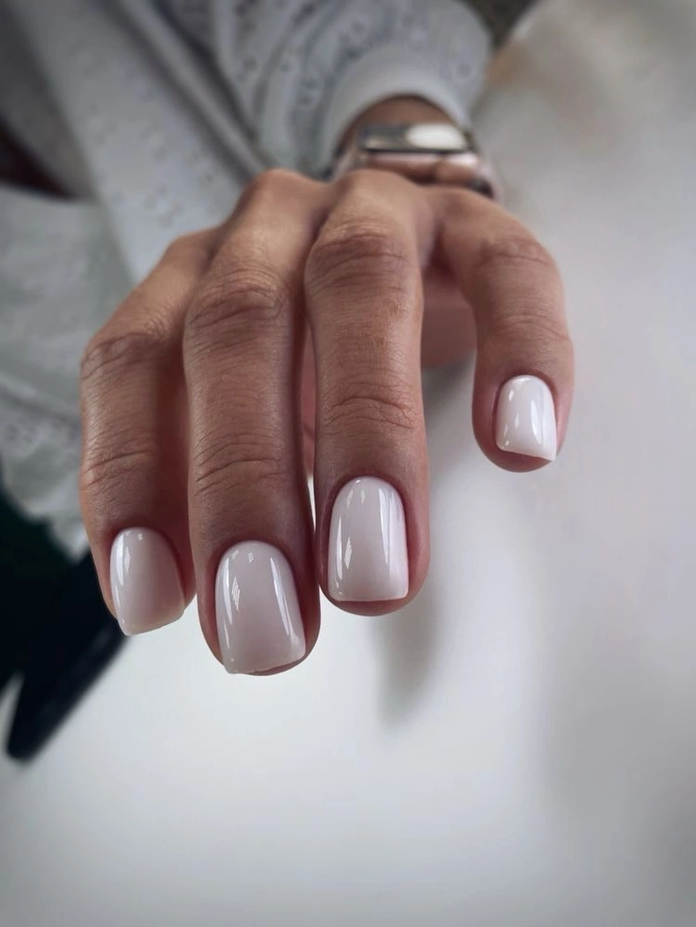 Short rounded square nails with sheer milky nude polish