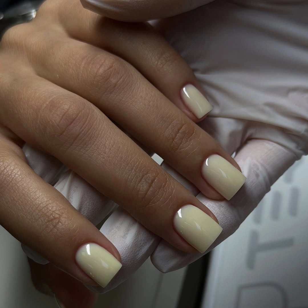 Short square cream nails with glossy rounded corners