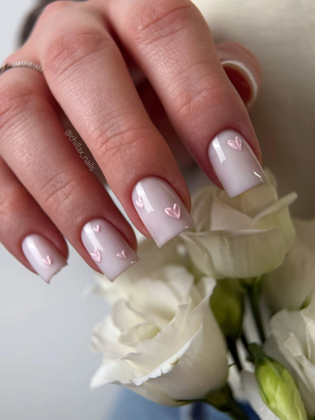 Milky pink square nails with small raised heart details