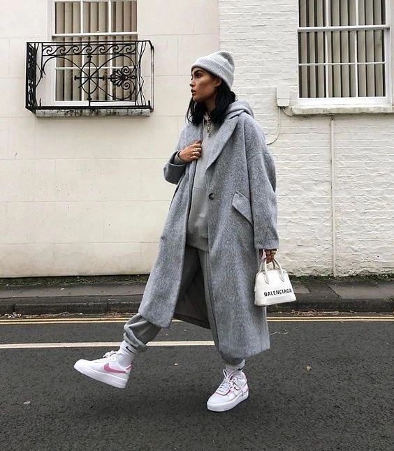 long gray coat scarf gray joggers pale pink sneakers and small white bag
