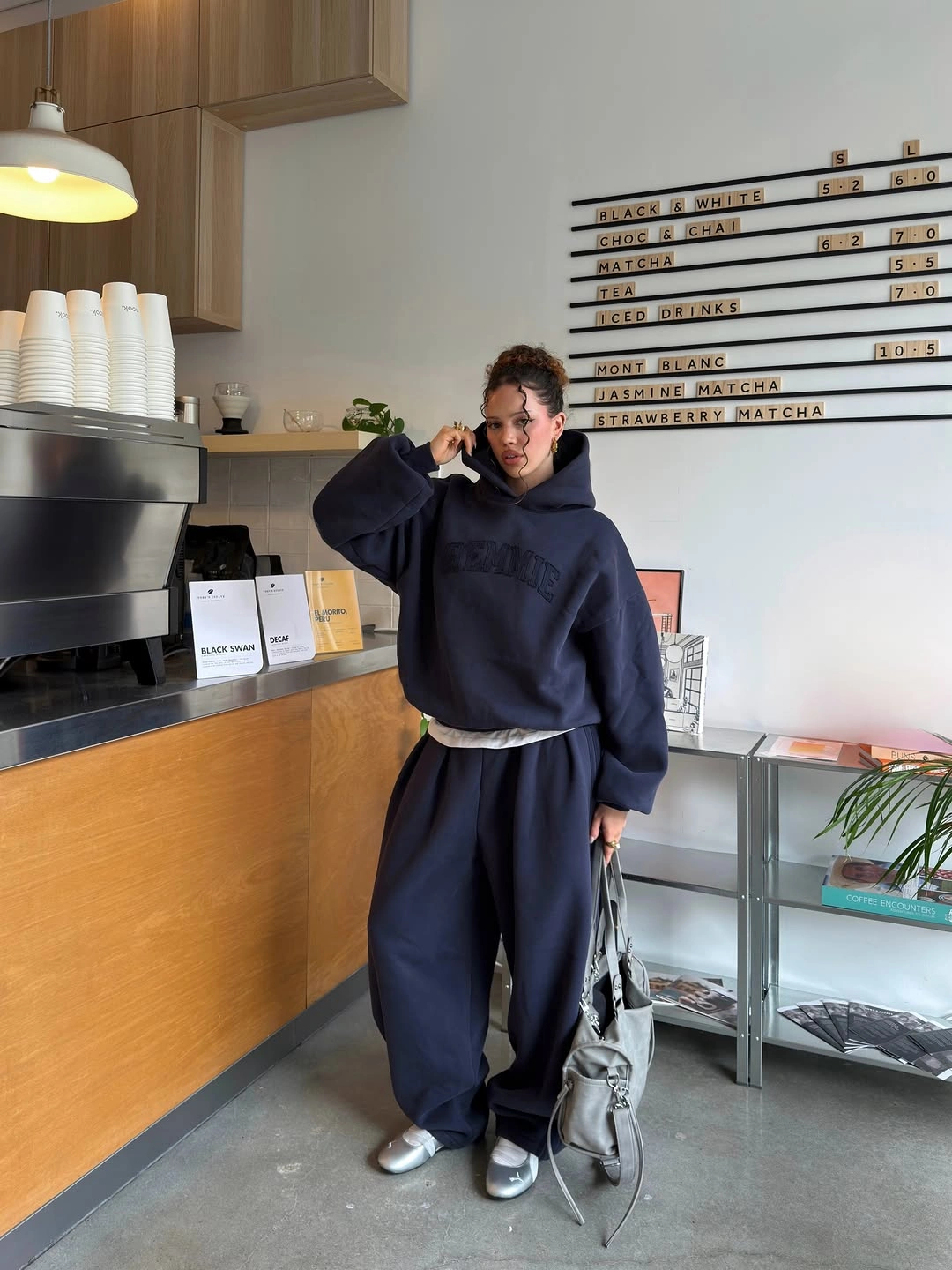 navy oversized hoodie and wide sweats with white hem metallic shoes and small bag