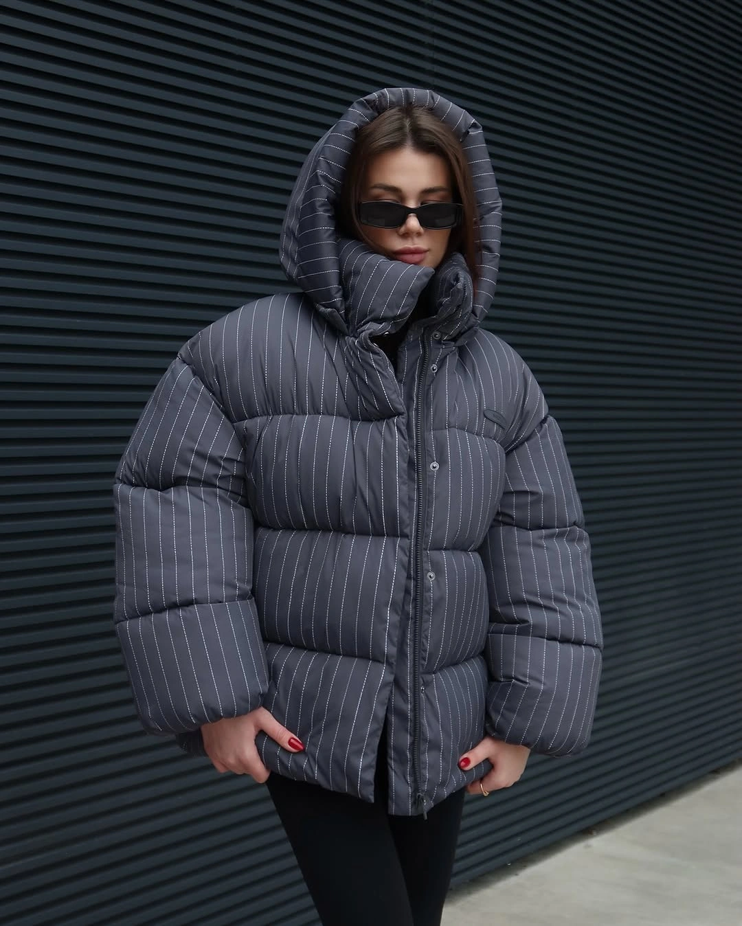 oversized charcoal pinstriped puffer with hood and black leggings