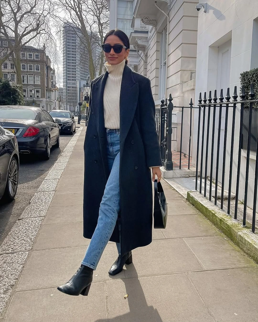 Long dark coat with cream turtleneck, jeans and black boots