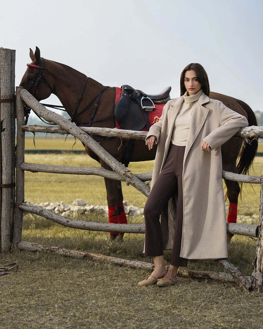 Long light beige coat with cream top and brown cropped trousers