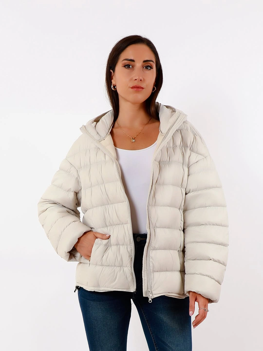White hooded short puffer with white tank and dark jeans