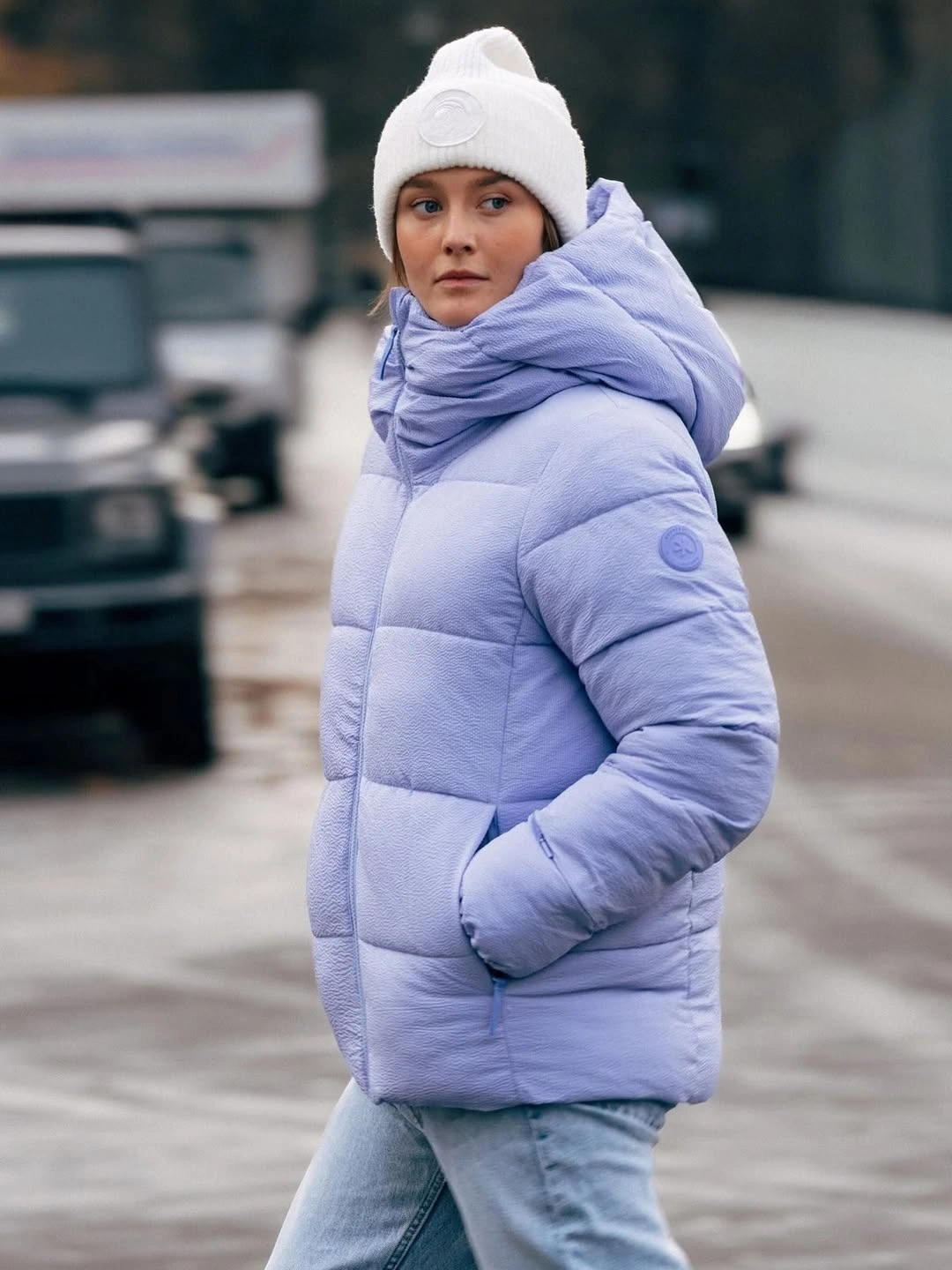 Light lavender puffer with white beanie and thick scarf