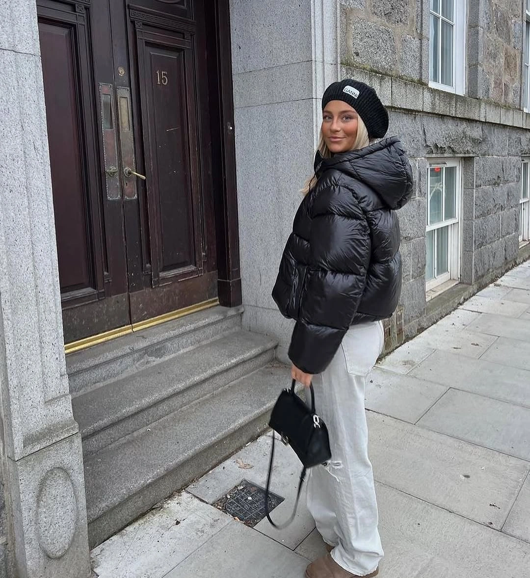 Black glossy cropped puffer with cream trousers and beanie