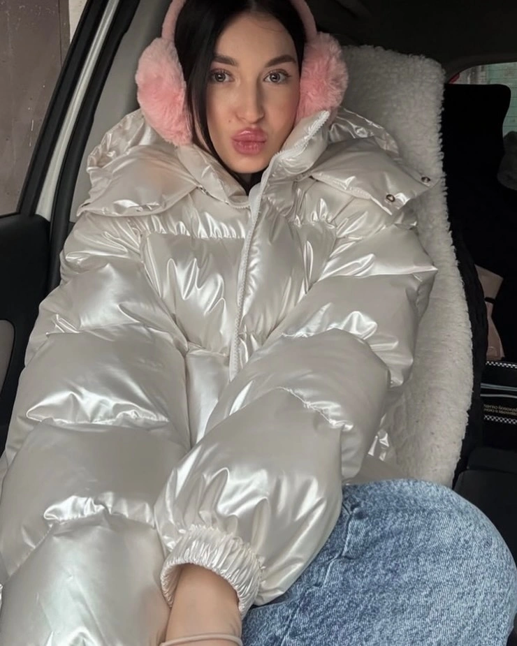 Metallic white oversized puffer with pink earmuffs and denim
