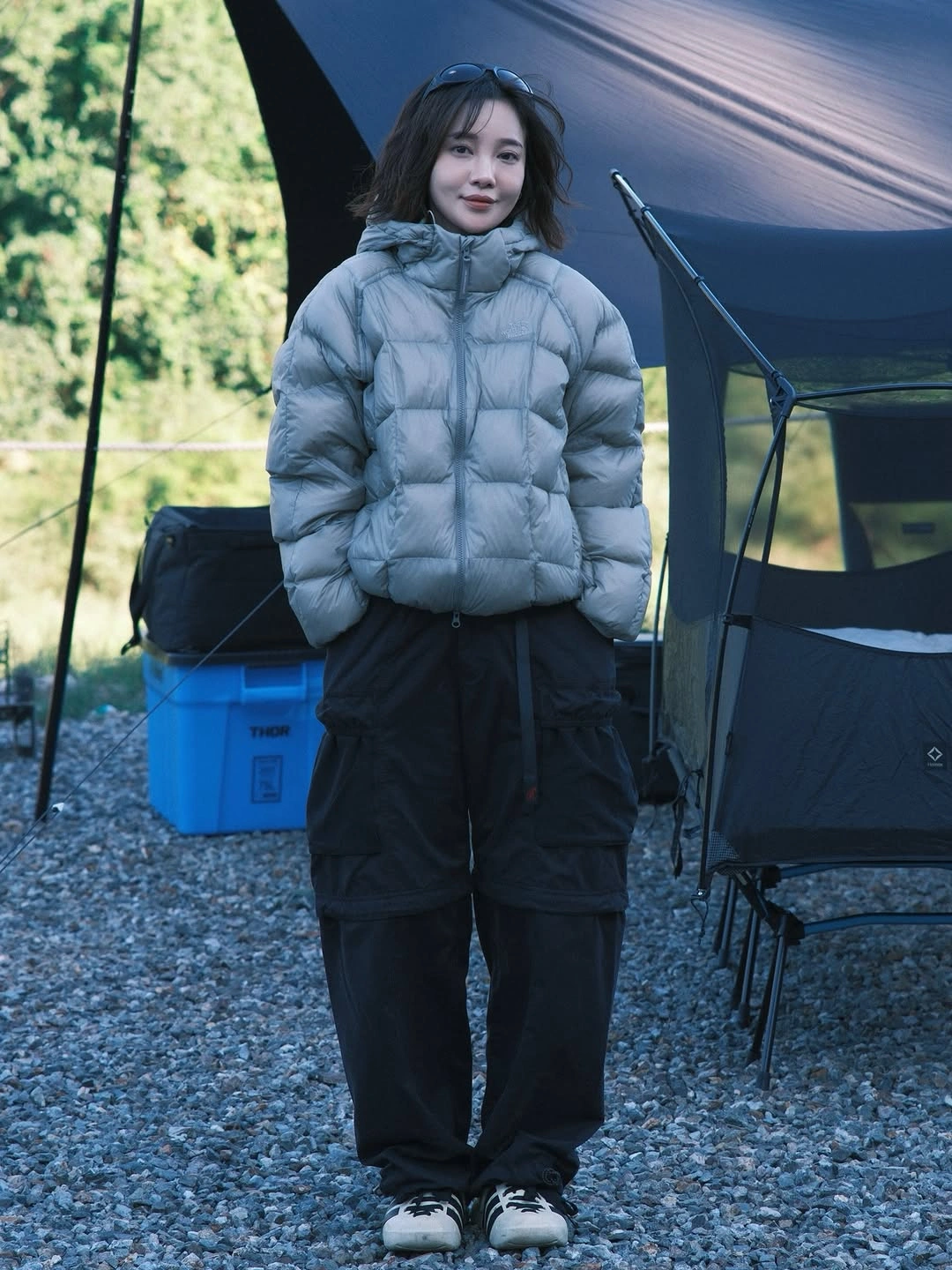 Pale blue gray puffer with black cargo pants and sneakers