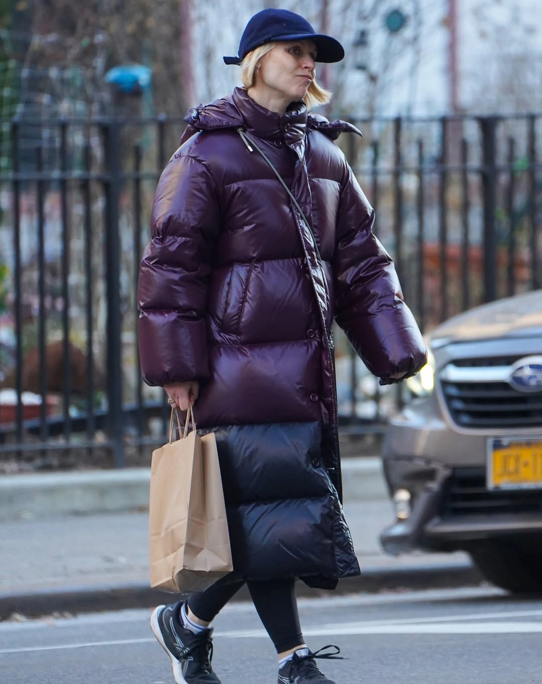Glossy purple puffer with long black quilted lower layer