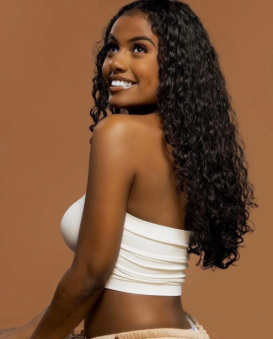 Long dark curls falling down the back with soft face pieces