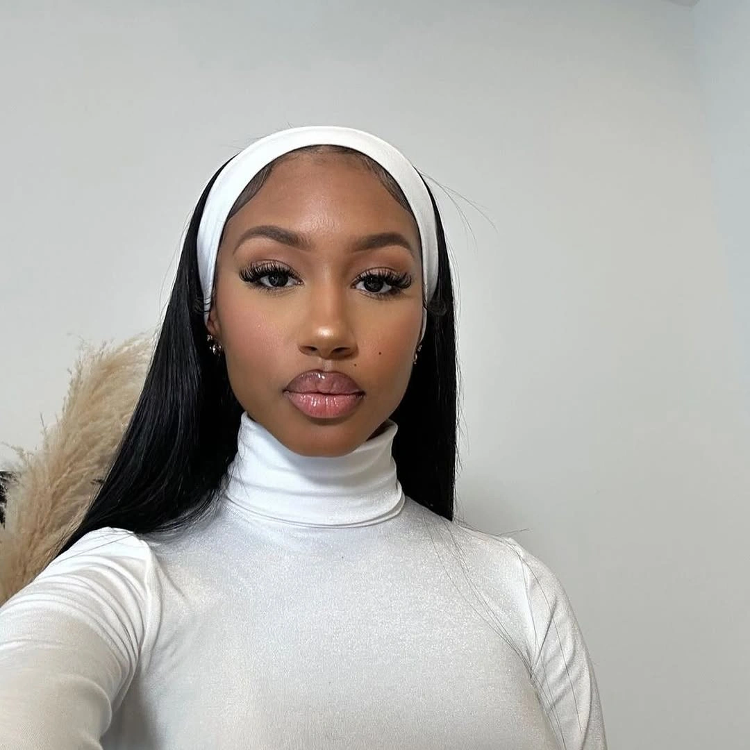 Long straight dark hair under a wide white headband