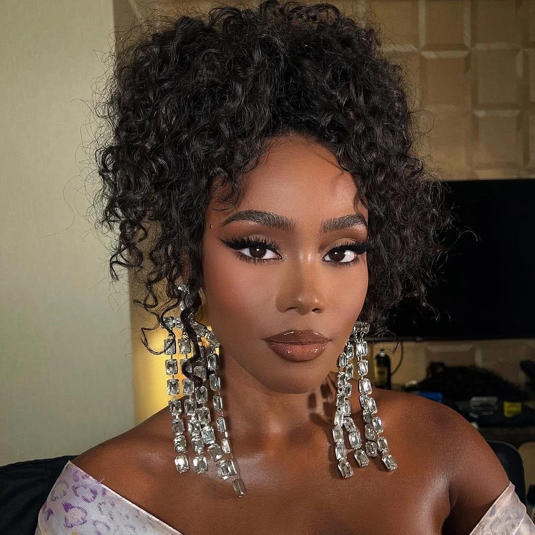 Lifted curly style with face curls and long crystal earrings