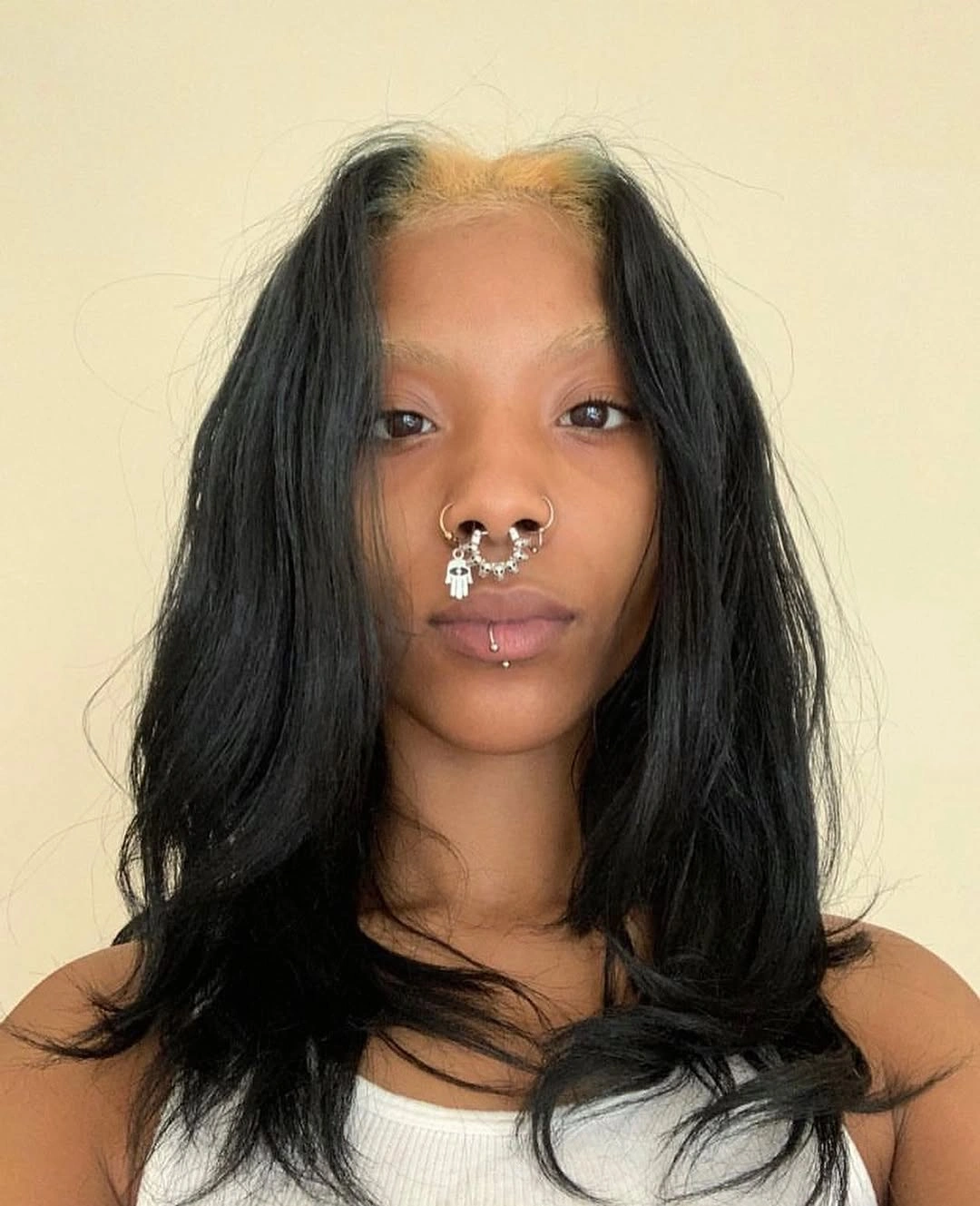 Medium dark hair with pale front section and flipped layered ends