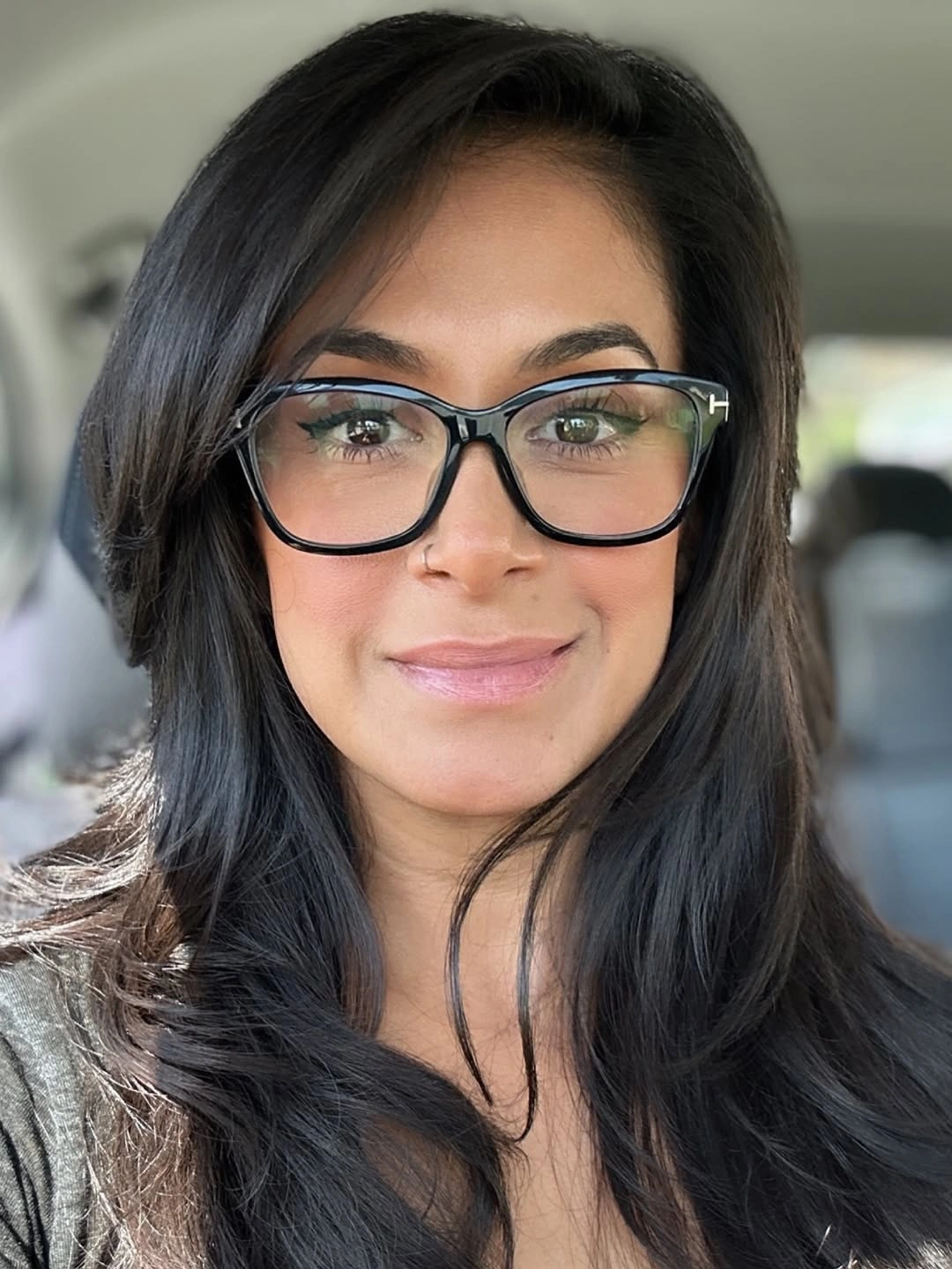Long dark layered hair with side-swept front and glasses