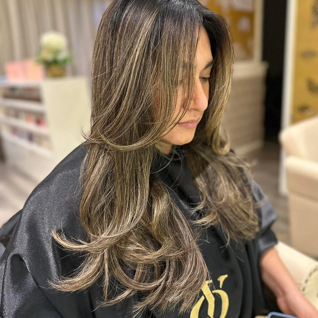 Long dark layered hair with golden face-framing pieces