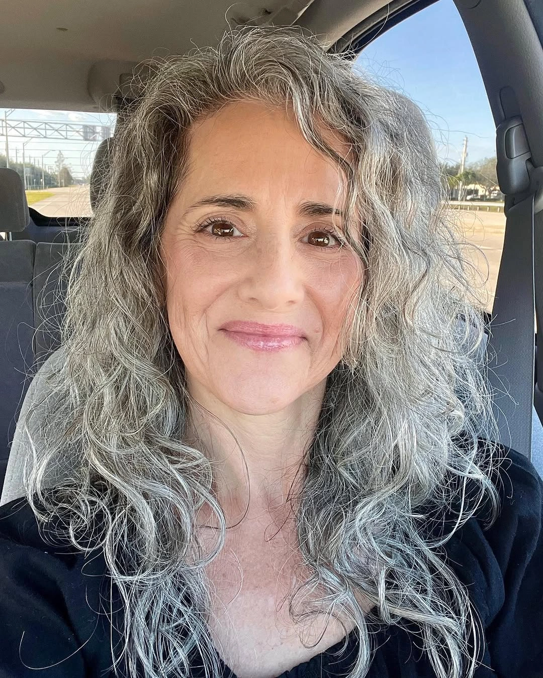Long gray wavy hair with full side volume