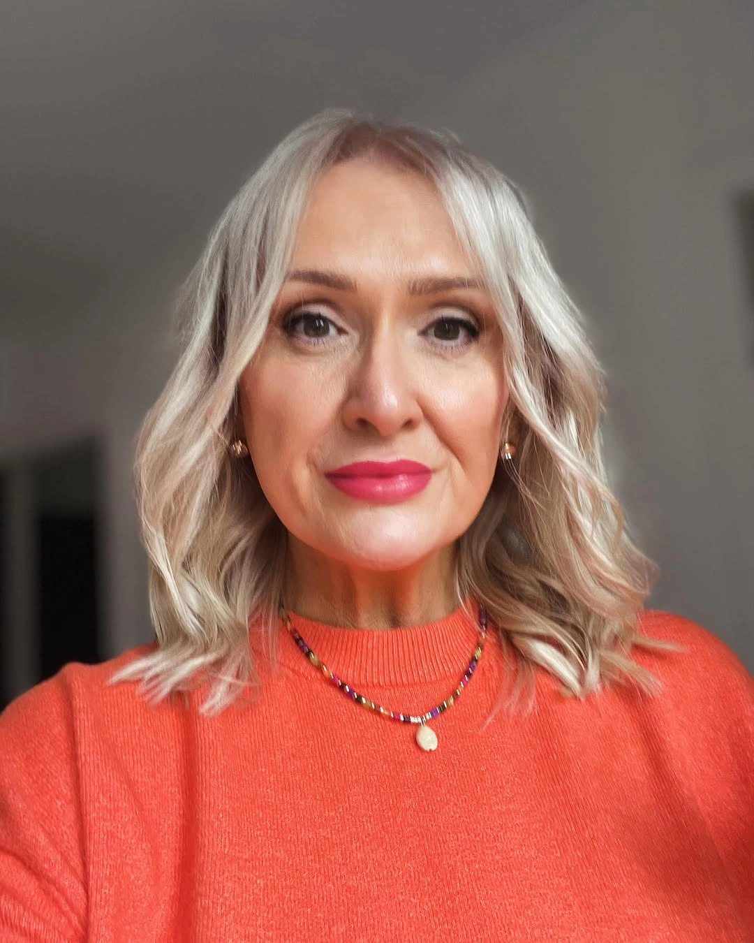 Shoulder length blonde waves with center part