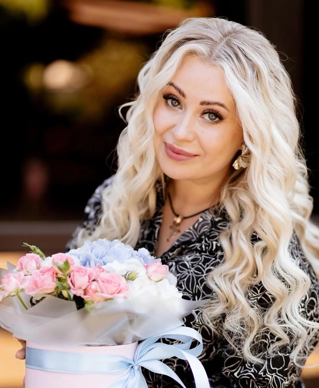Long platinum blonde wavy hair falling past shoulders