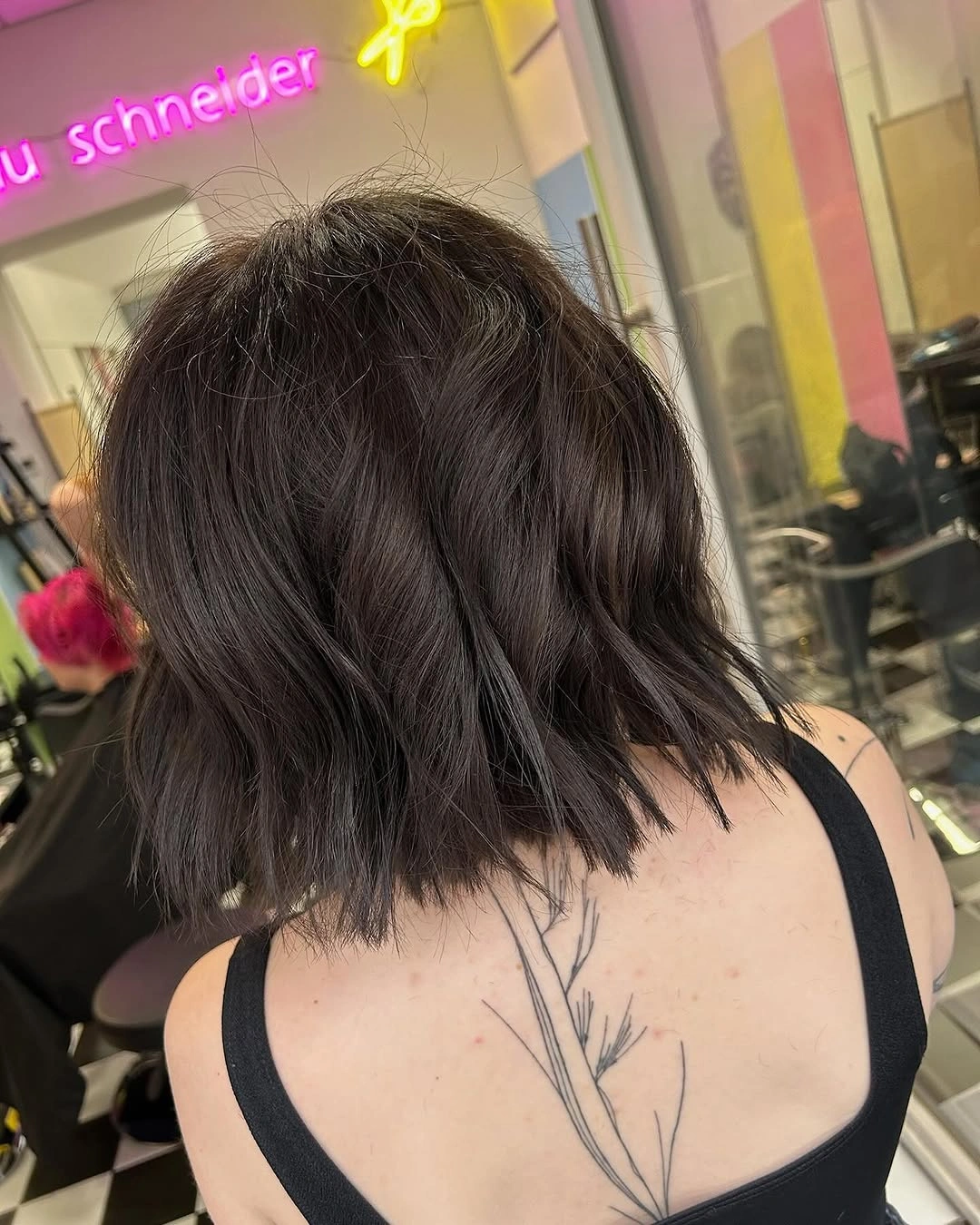 Dark shoulder-level wavy hair viewed from the back