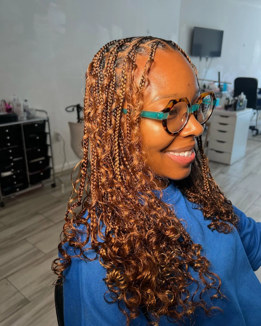 Warm brown small braids with curled loose ends