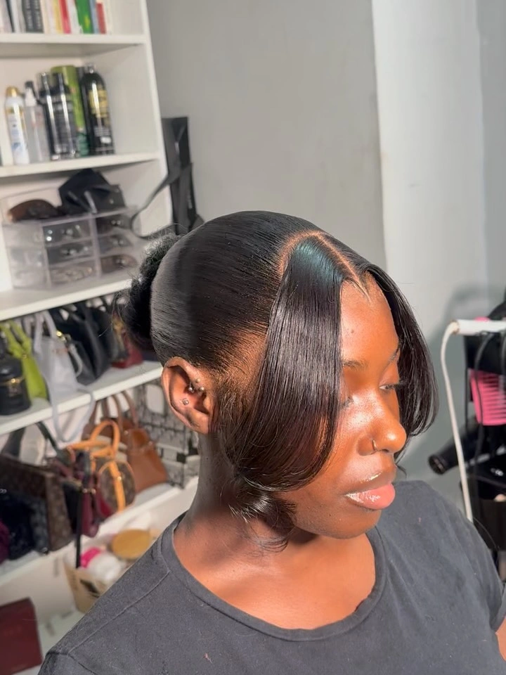 Glossy dark side-parted hair in a low gathered style