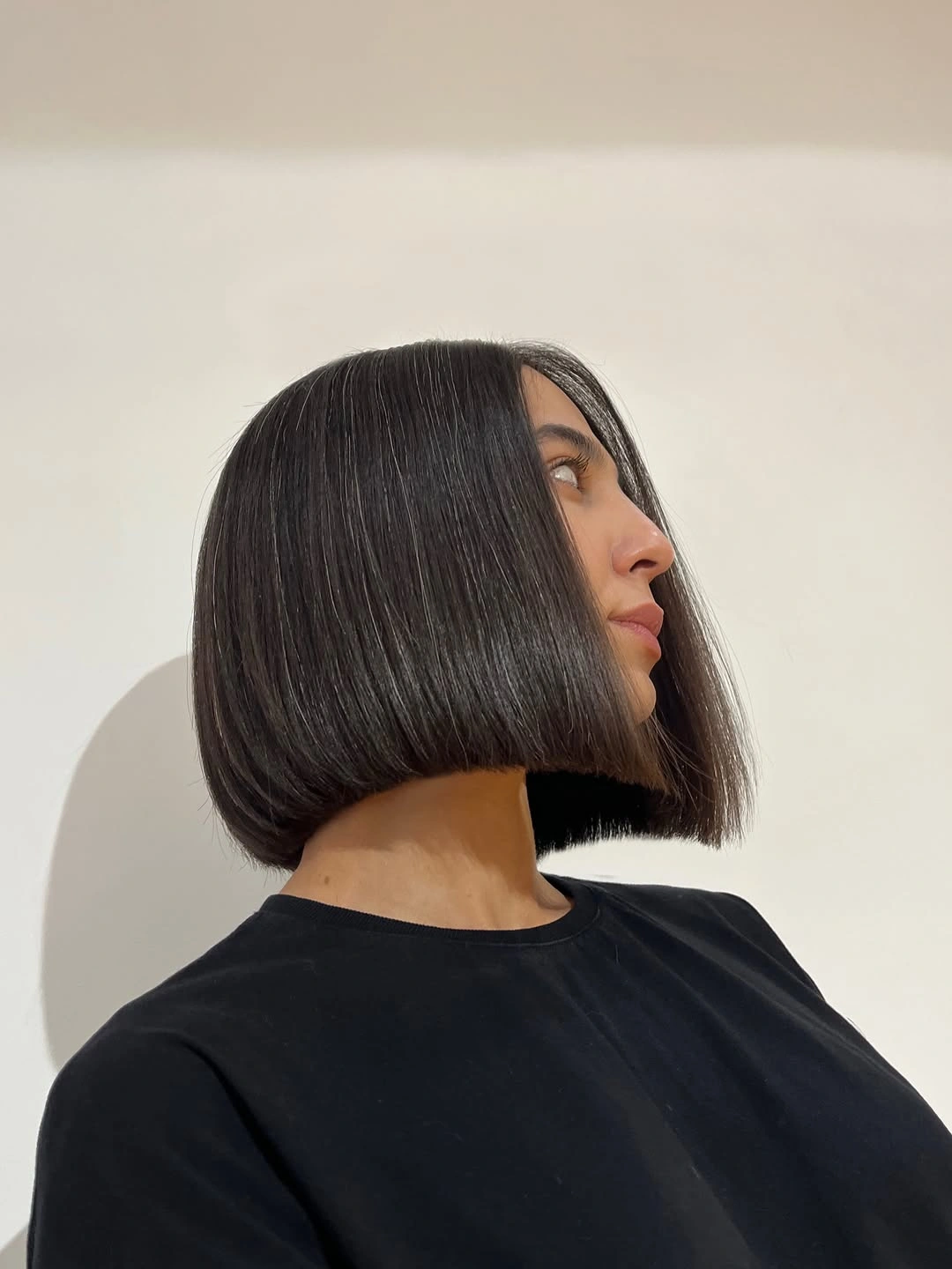 Dark short straight hair with blunt side edge