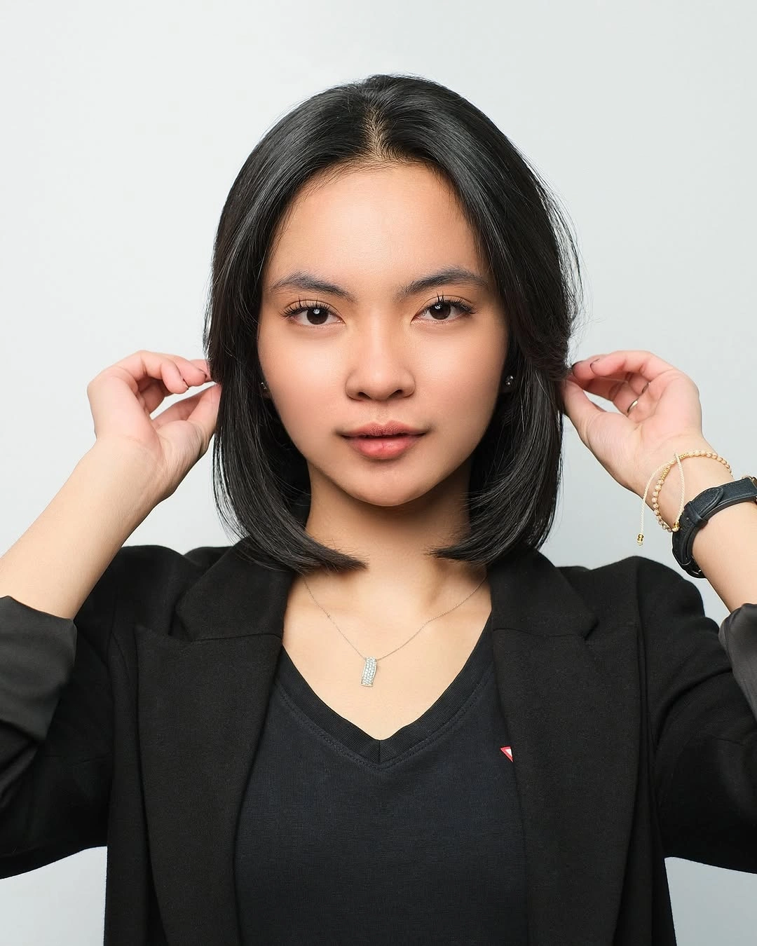 Dark medium straight hair with center part and rounded ends