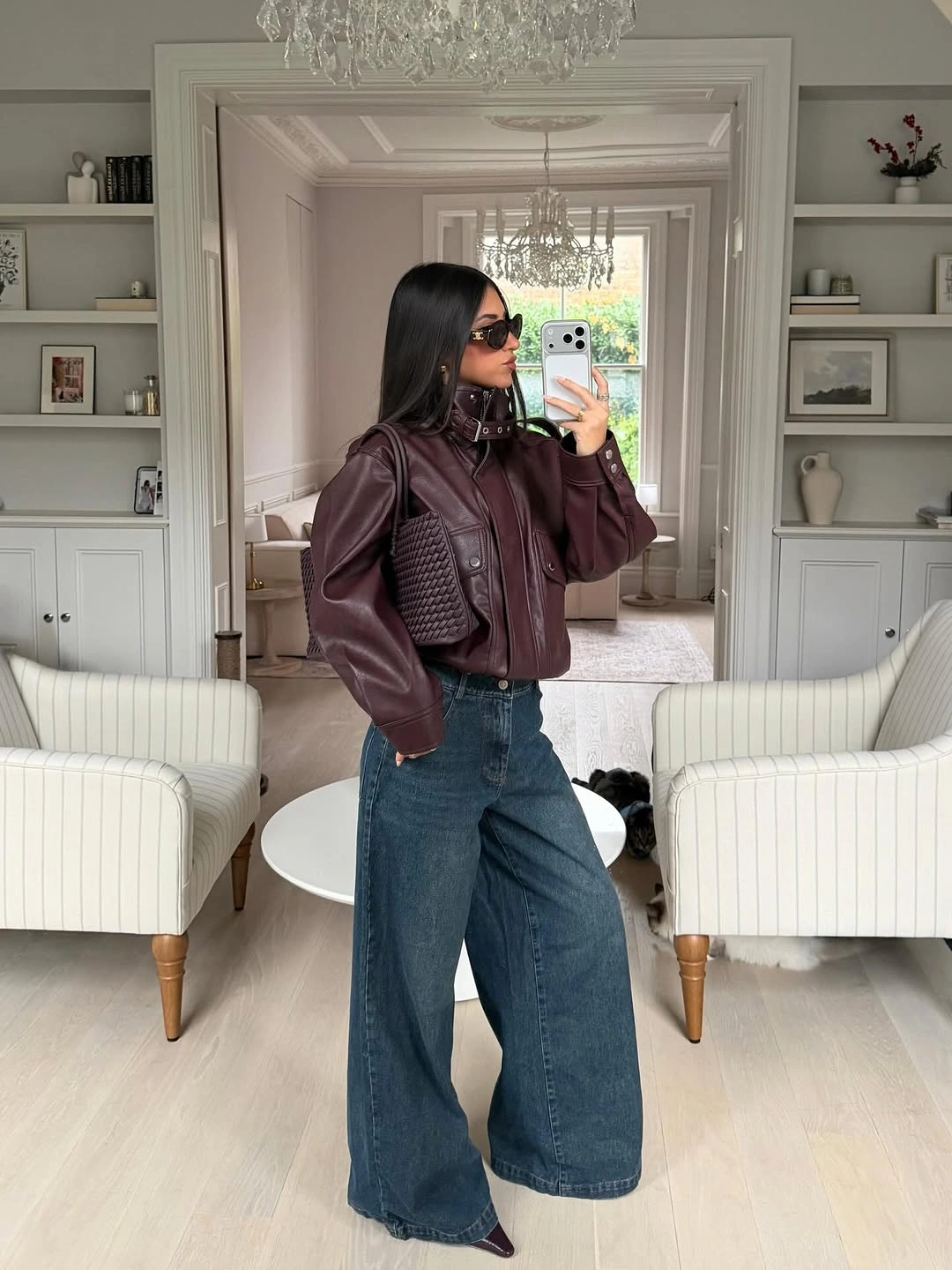 Burgundy jacket with wide jeans and matching woven bag