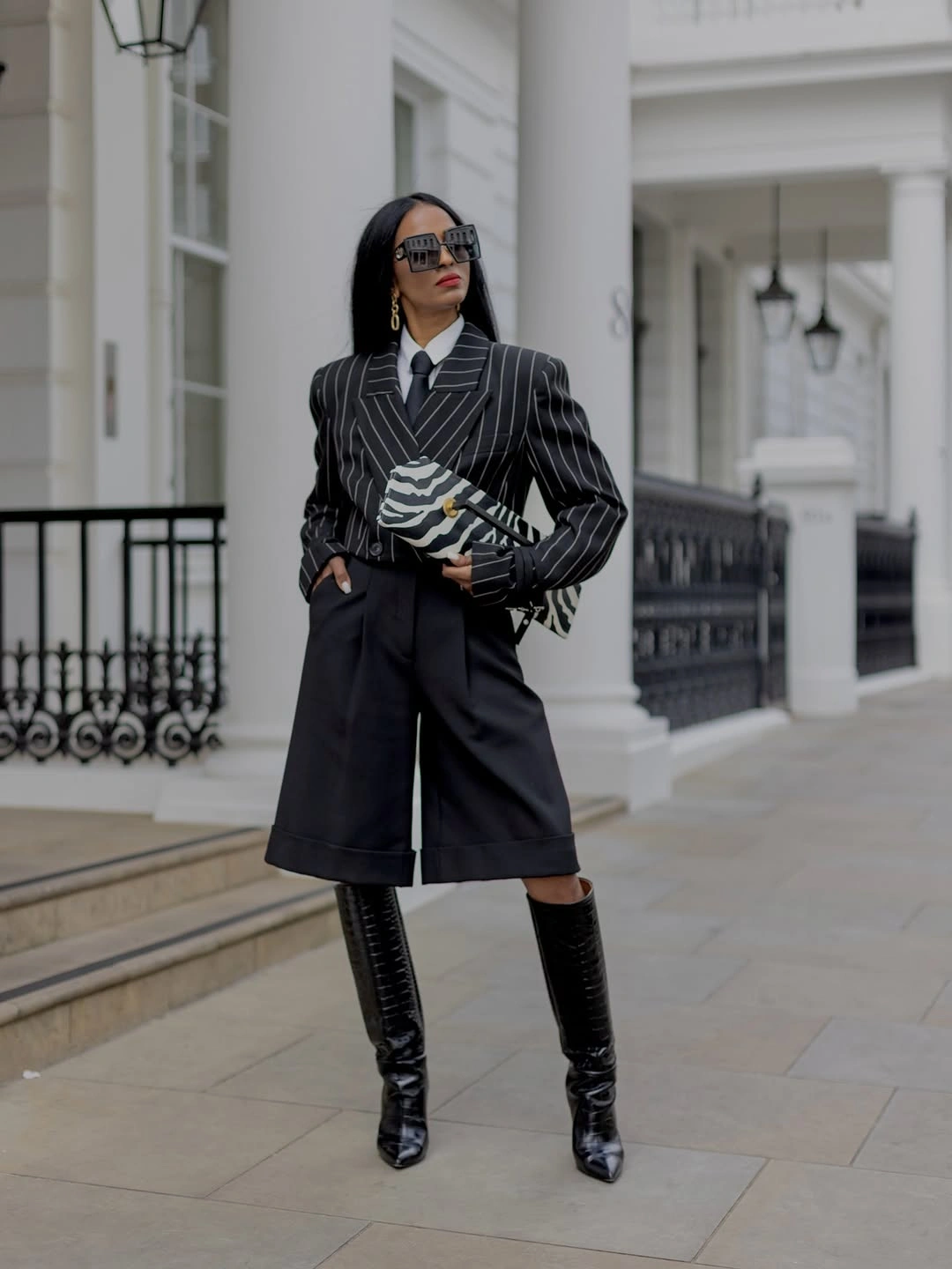 Pinstripe blazer with tie, long shorts and tall boots