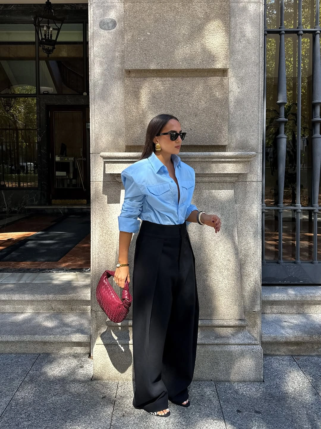 Light blue shirt with black trousers and burgundy handbag