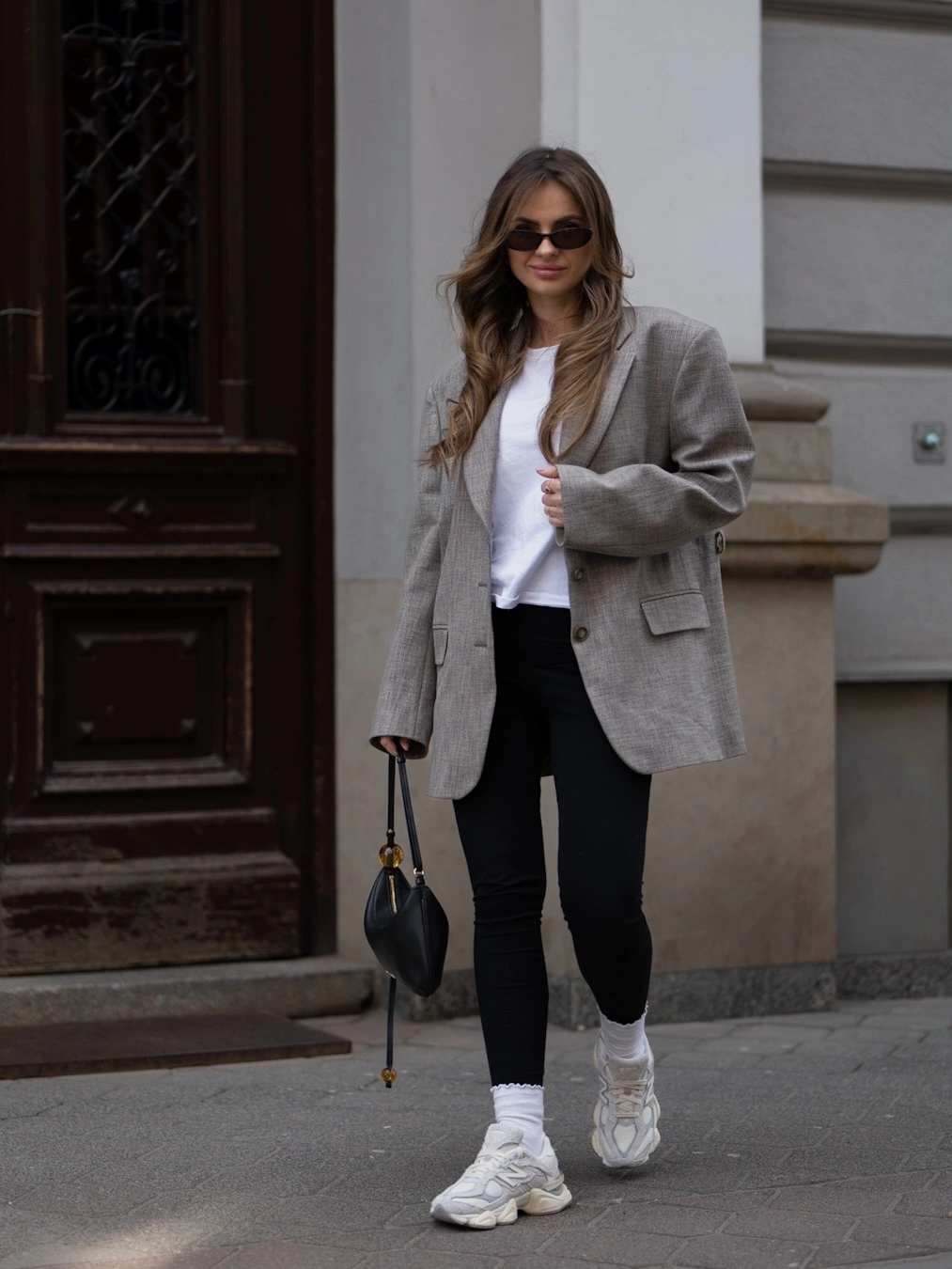 Gray blazer with white tee, black pants and chunky sneakers