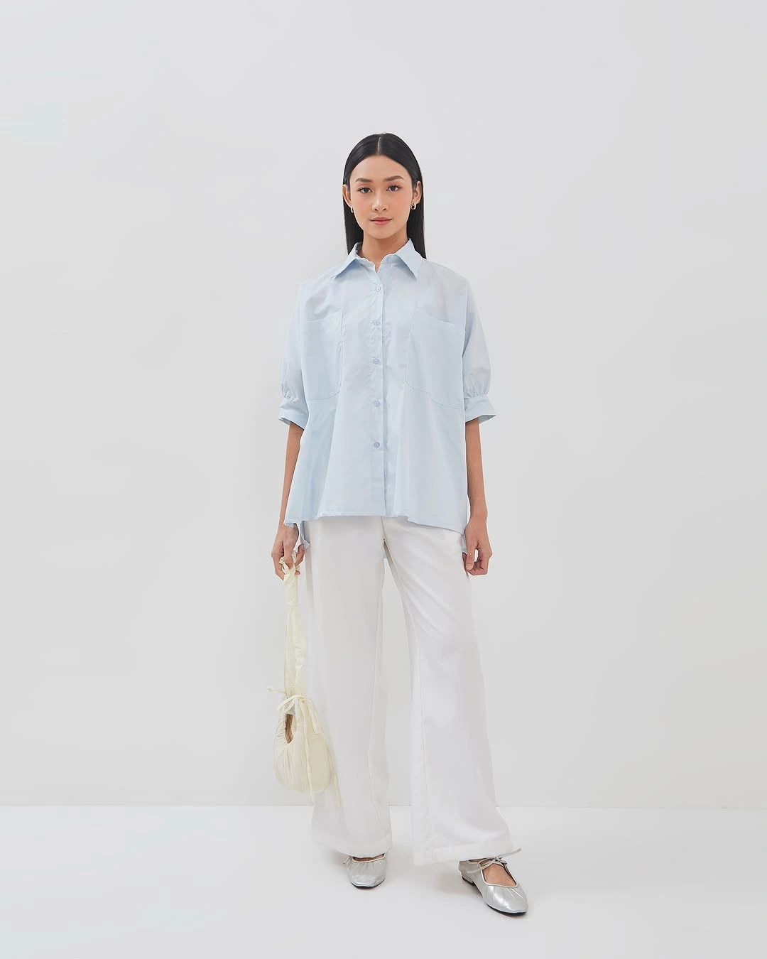 Pale blue shirt with white wide-leg trousers and silver flats