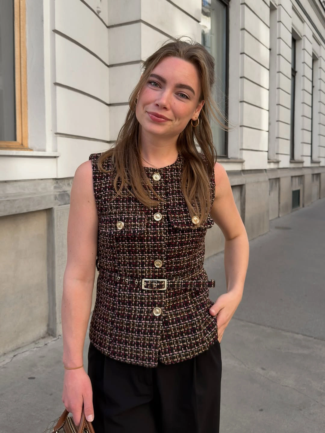 Textured sleeveless vest with gold buttons and black trousers
