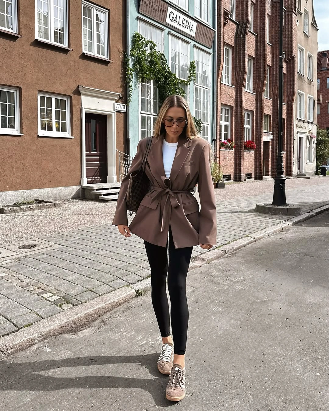 Taupe wrap blazer with black leggings, sneakers and woven tote