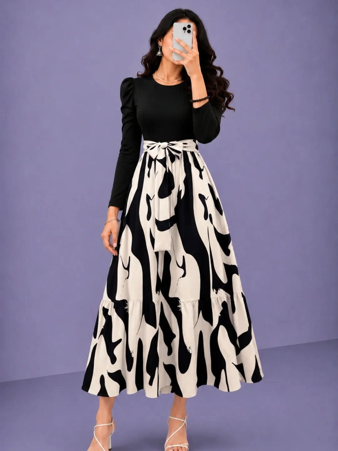 Black puff-sleeve top with white printed skirt and strappy heels