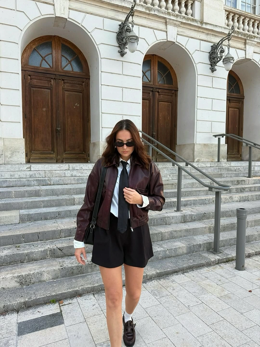 Burgundy-brown jacket, white shirt, black tie, shorts and loafers
