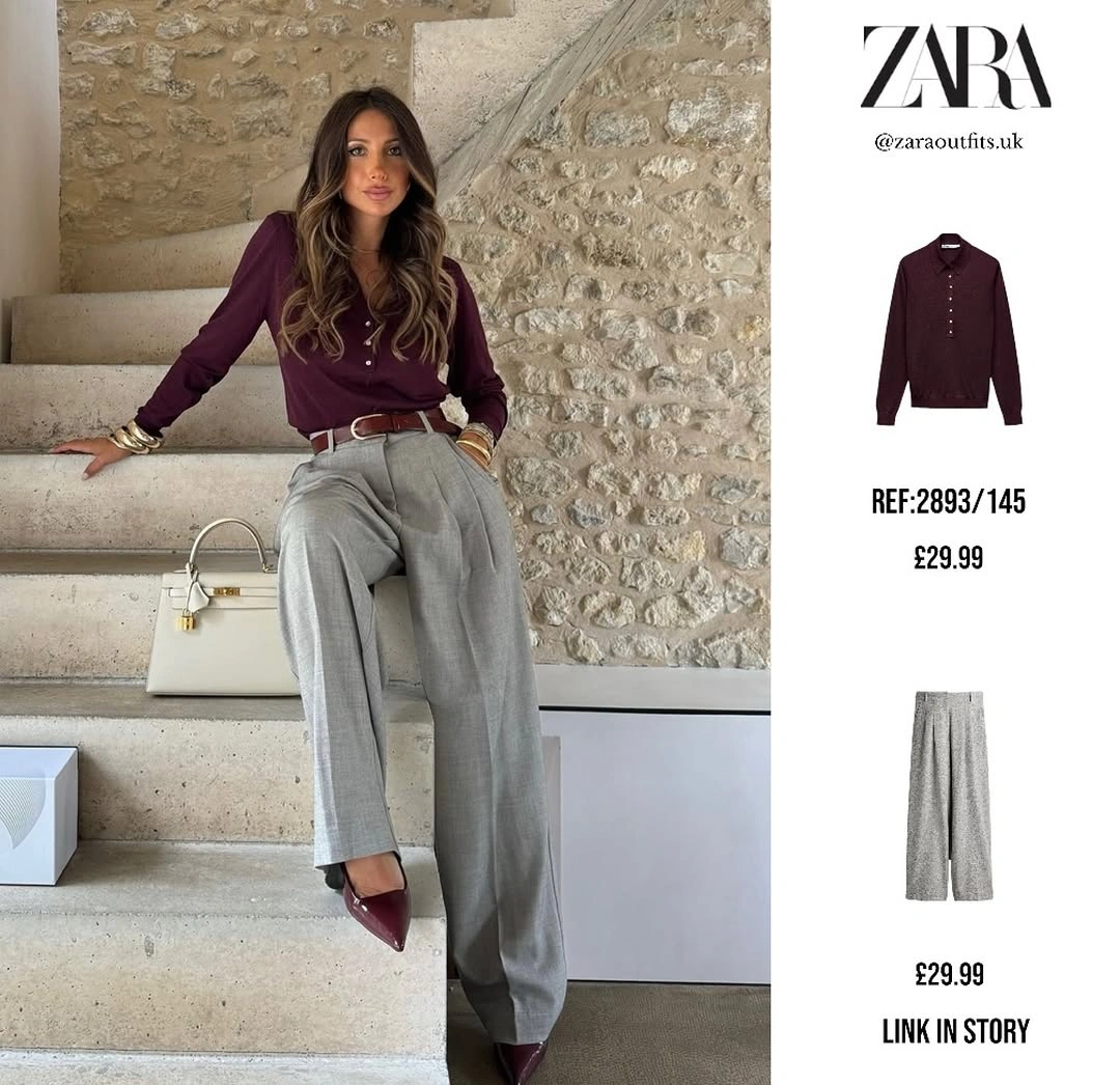 Burgundy button top with gray pleated trousers and white handbag