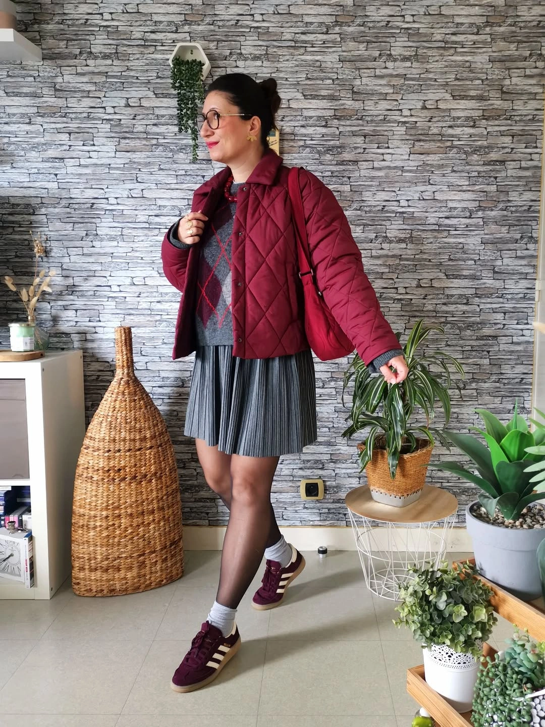 Burgundy quilted jacket with argyle knit, pleated skirt and sneakers