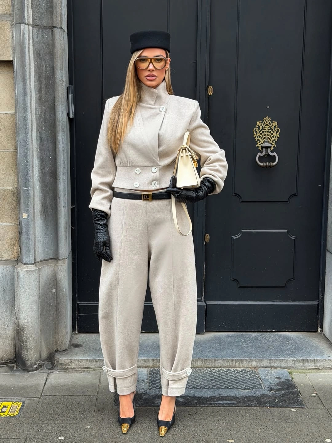 Cream high-neck set with black hat, gloves, belt and heels
