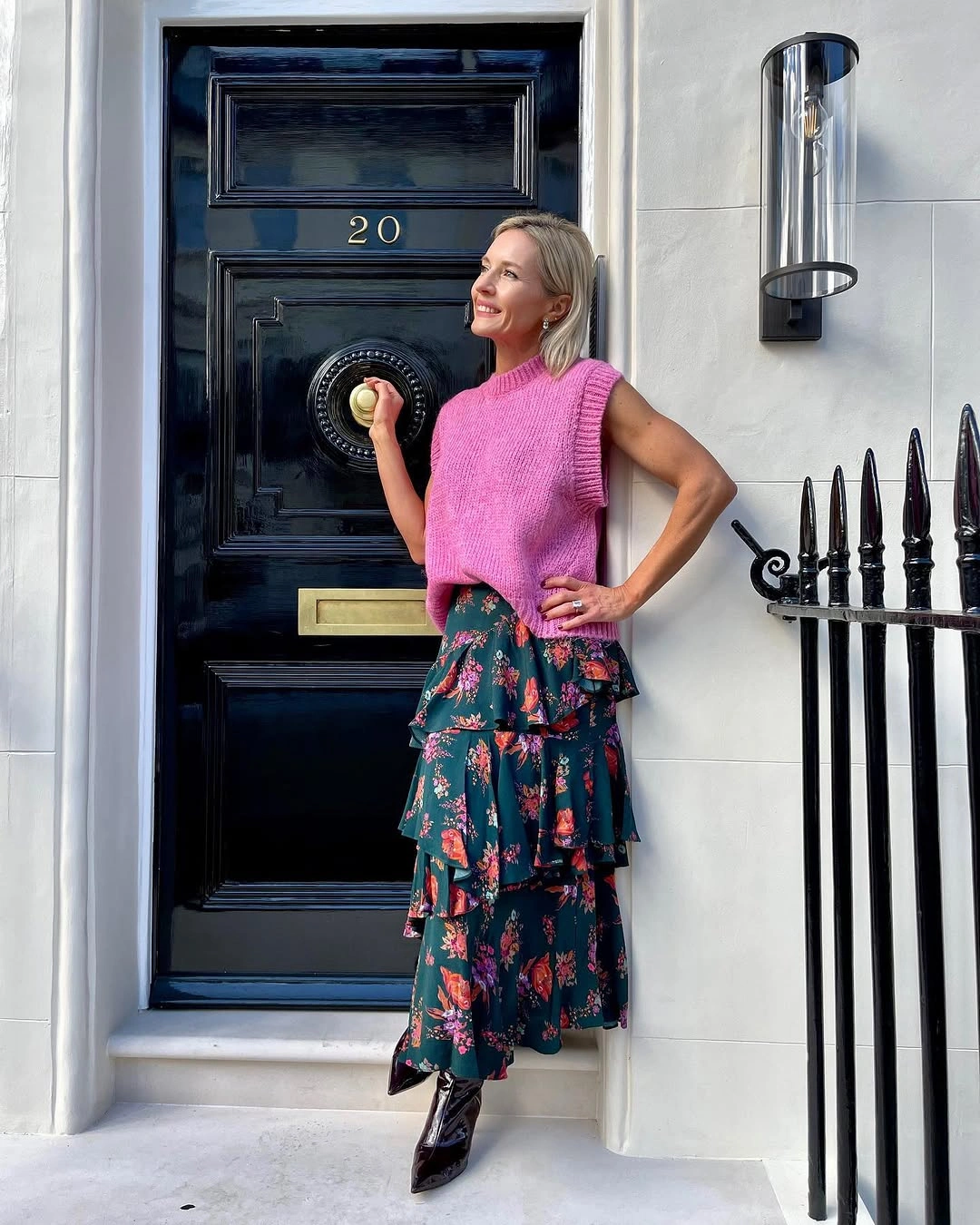 Pink sleeveless knit with dark floral skirt and black boots