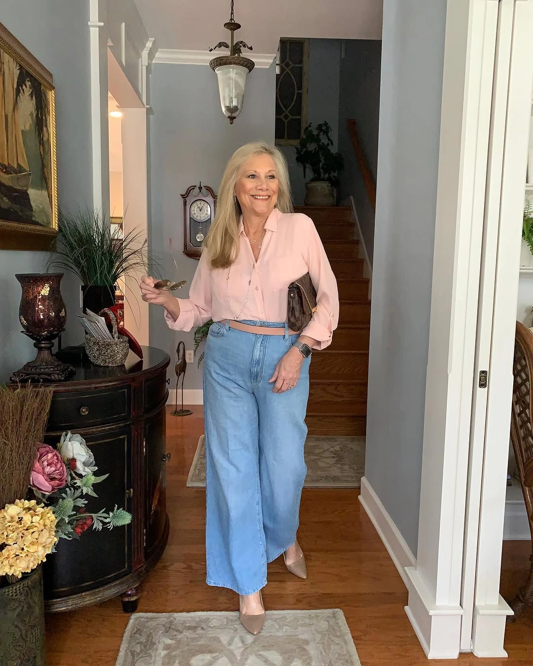Pale pink cropped shirt with wide jeans and pointed heels