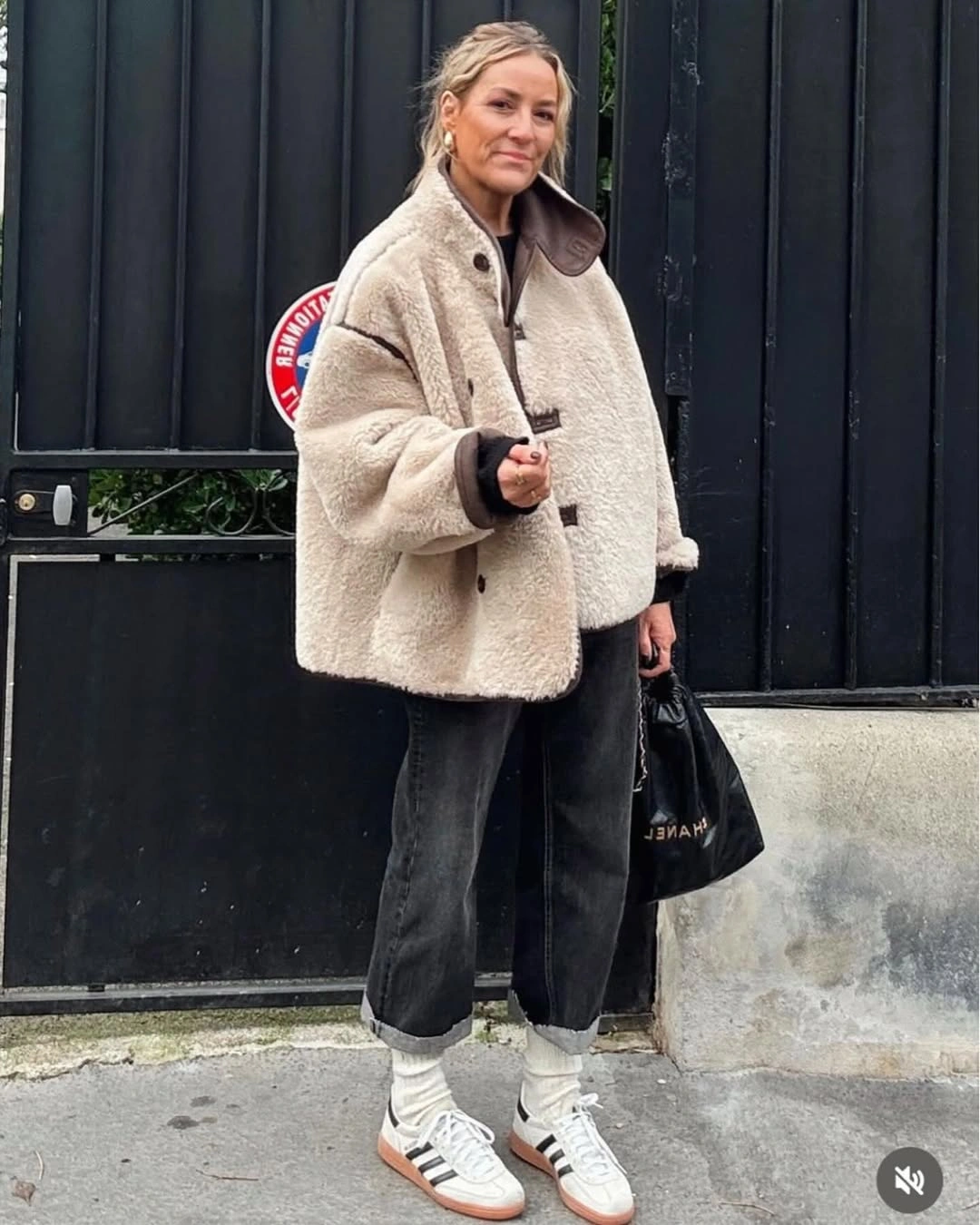 Cream textured toggle jacket with cuffed jeans and white sneakers