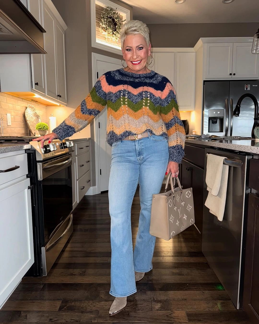 Colorful chevron sweater with flared jeans and taupe accessories