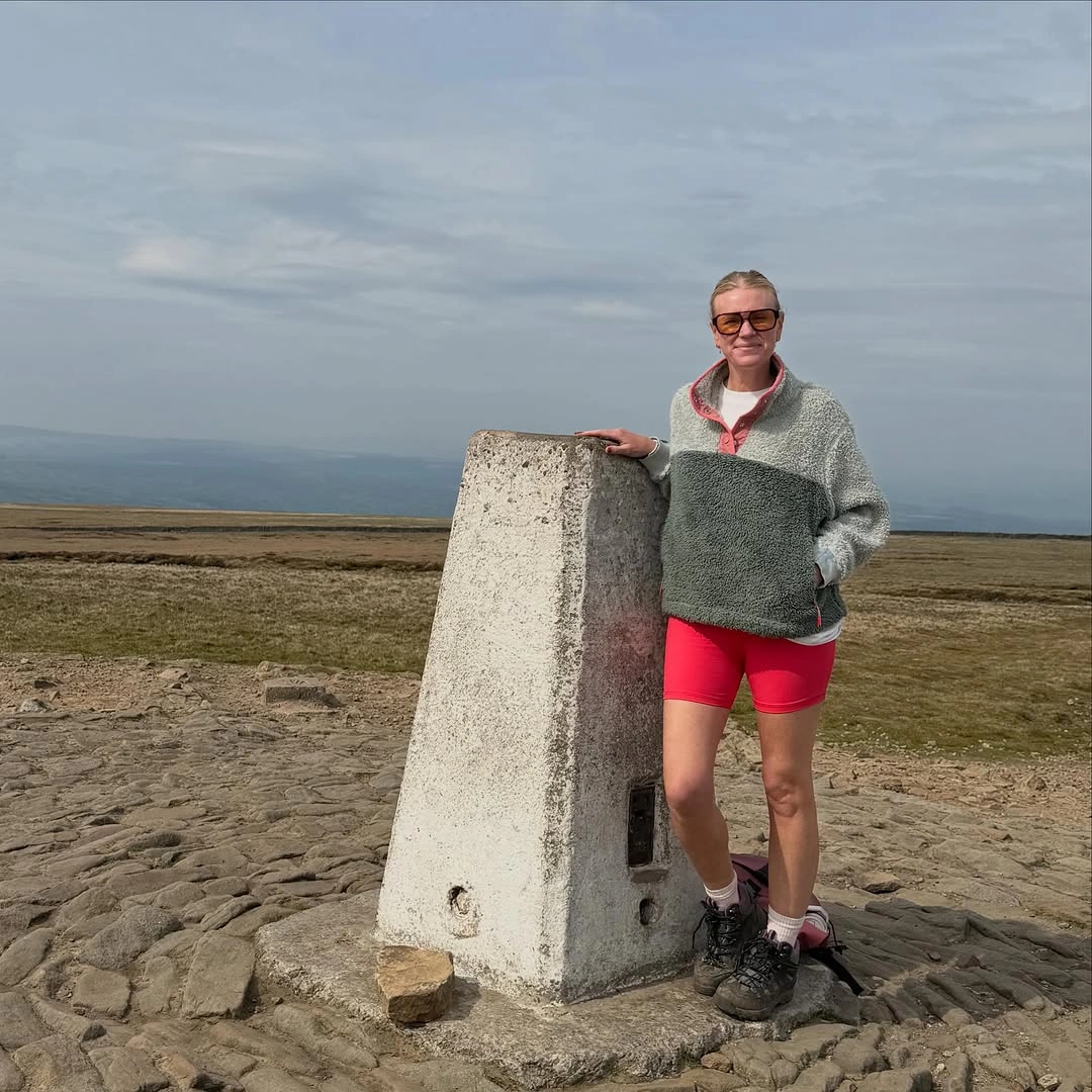 Gray textured pullover with coral shorts and dark hiking boots