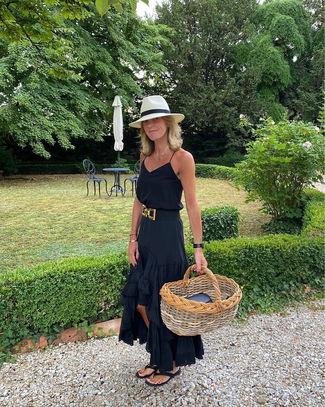 Black belted ruffled outfit with straw hat and wicker basket