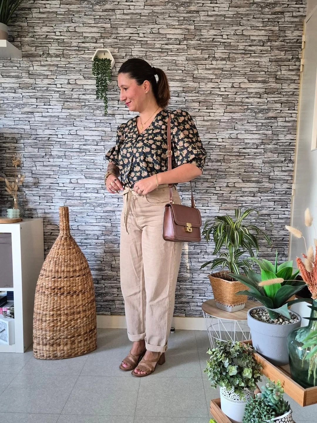 Dark printed blouse with beige cuffed trousers and brown sandals
