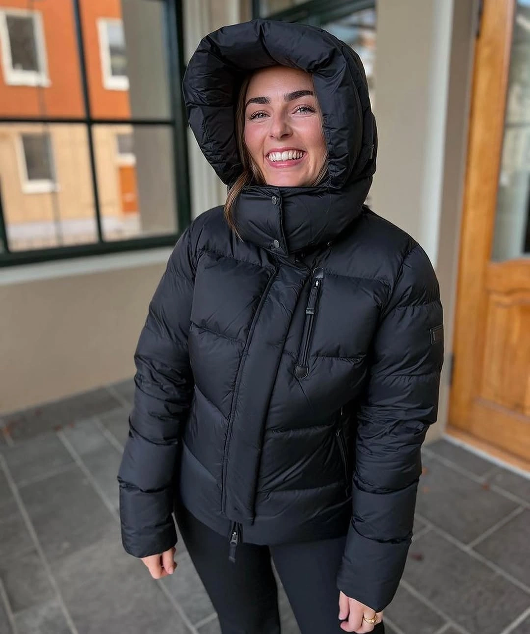 Black hooded puffer zipped high with fitted black bottoms
